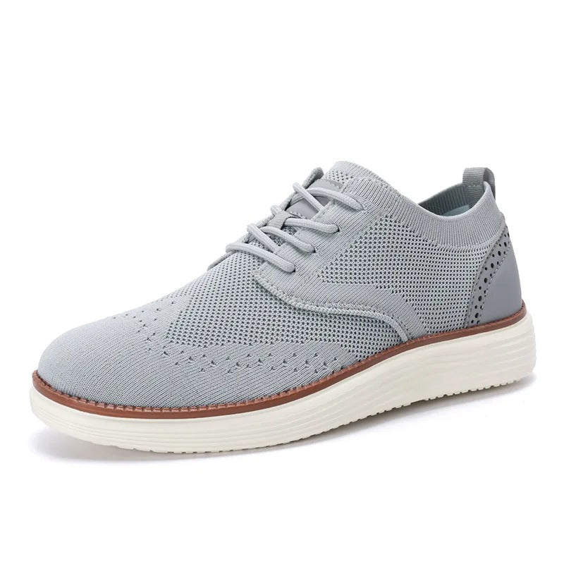 Men's hybrid dress sneakers with a knit bootie for a snug fit and wingtip details for a refined touch.