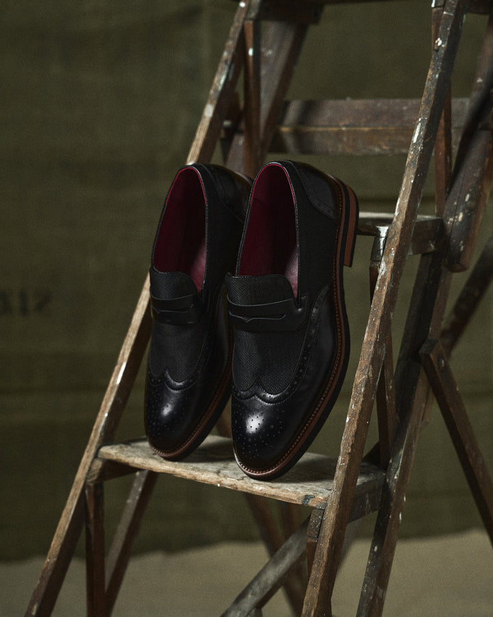 Close-up of men's hybrid wingtip loafers showing detailed brogue design, versatile men's footwear