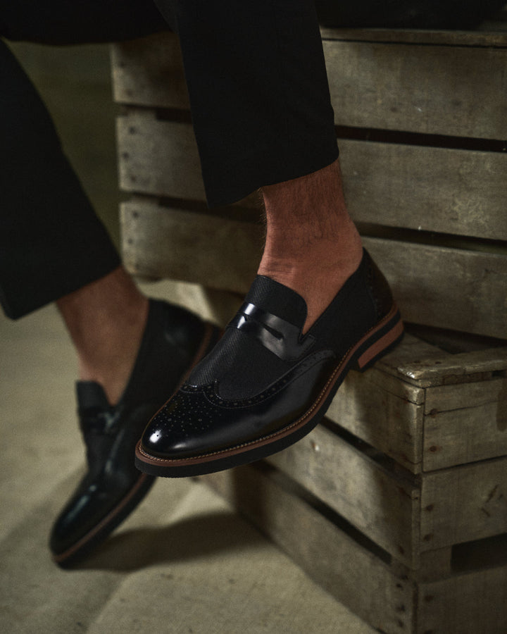 Pair of grey men's hybrid wingtip loafers, combining casual comfort with formal shoe elegance