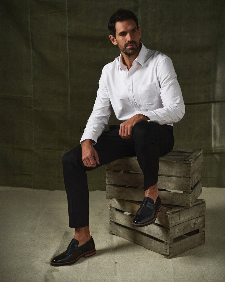 Classic black men's hybrid wingtip loafers with a durable sole, ideal for all-day wear
