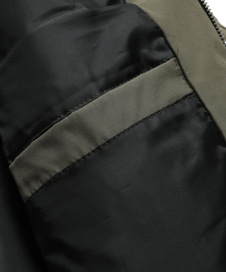 Studio shot of a men's insulated bomber jacket, emphasizing its clean lines and puffer design.