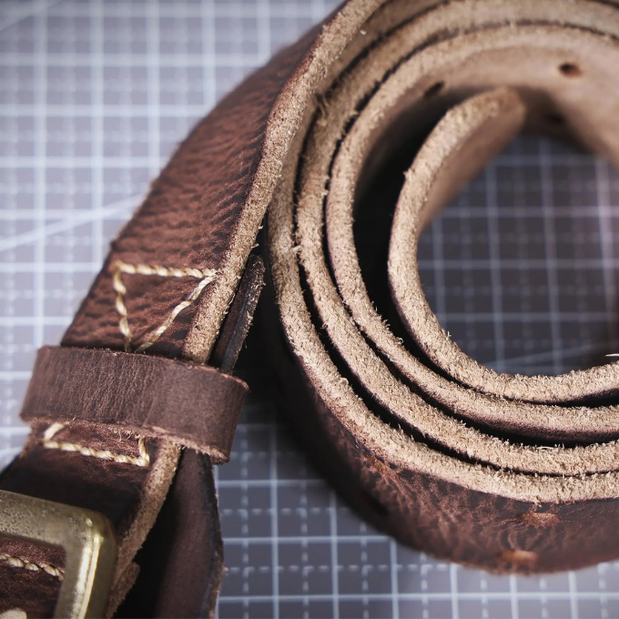Pairing a men's rugged Italian leather belt with jeans, emphasizing its workwear suitability.
