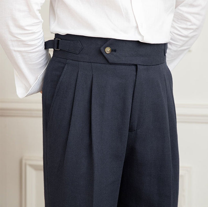 Stylish men's high-waisted formal trousers with precise pleating for a classic fit.