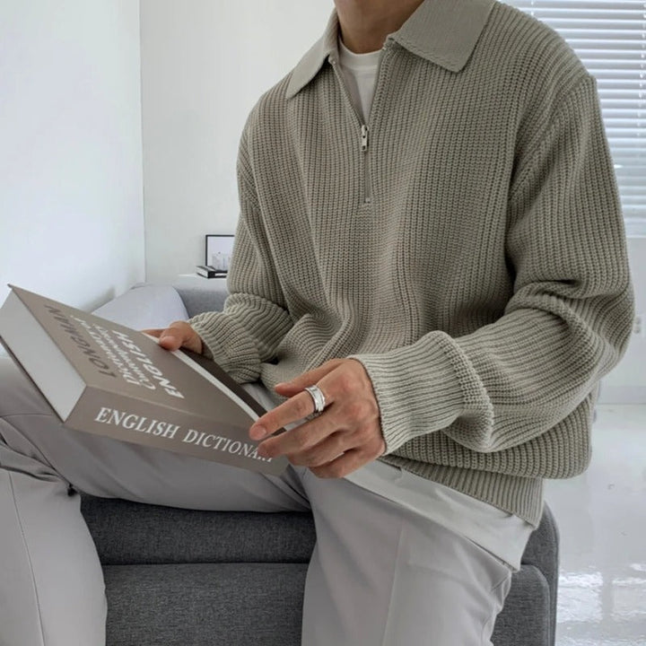 Man modeling a versatile jacquard knit quarter zip sweater, showcasing its comfortable fit and style.
