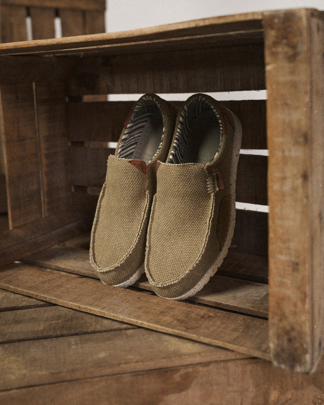 Side view of a man's gray canvas slip-on shoe with white sole for comfort