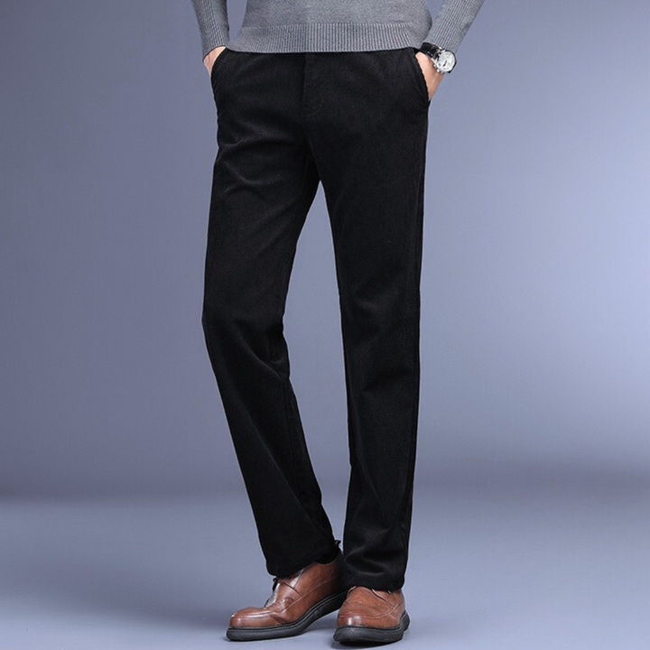 Dark brown corduroy stretch trousers for men, close-up of fabric, showcasing quality and feel.