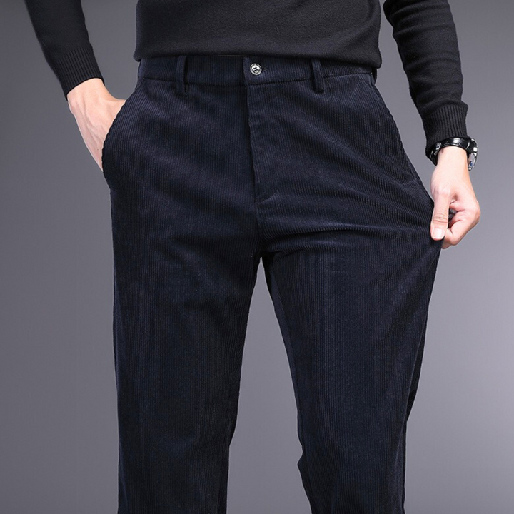 Black stretch corduroy pants, detail of waistband and button, combining comfort & formal wear.