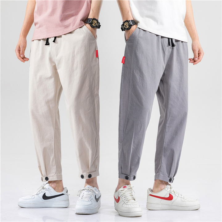 Close-up of black linen blend fabric on men's tapered cropped trousers, comfortable design