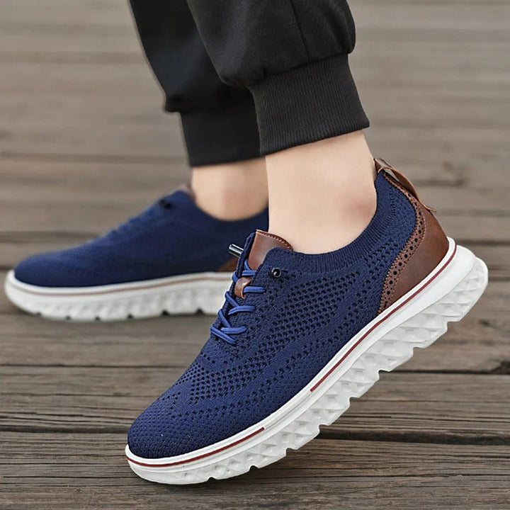 Men's casual brogue knit sneakers in a rich navy, offering a blend of flexibility and sophistication.