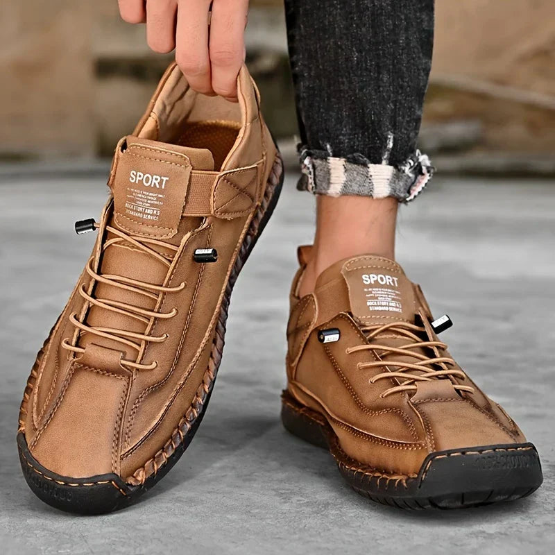 Men's wide fit black leather orthopedic sneakers, emphasizing abundant toe room for comfort.