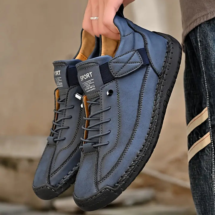 Side profile of men's orthopedic leather sneakers, black, highlighting supportive arch and wide fit.