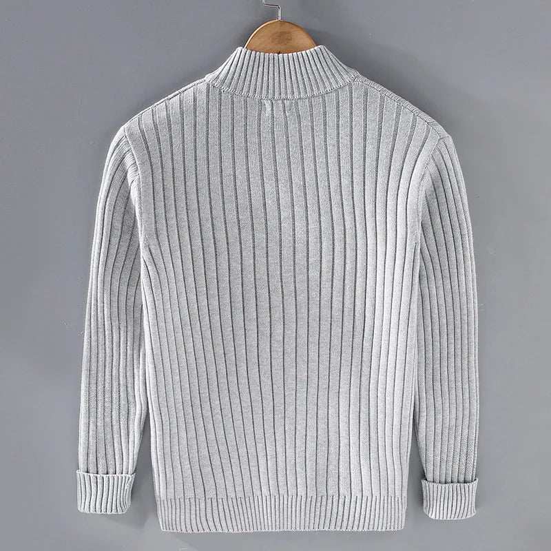 Model wearing a men's dark blue ribbed knit zip-front sweater, showing versatility and style