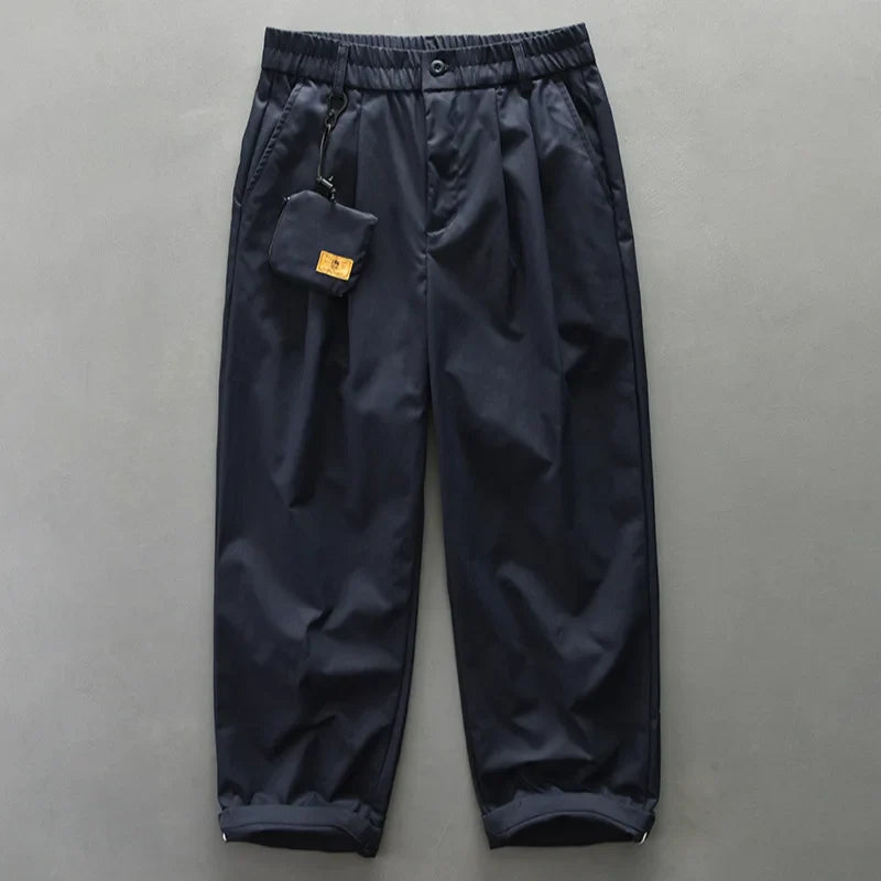 Close-up of men's utility pants fabric, highlighting lightweight and water-resistant features for travel