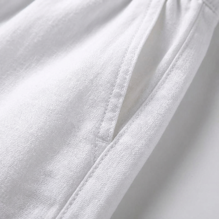 Relaxed fit men's travel and loungewear pants with an elastic drawstring waist for comfort.