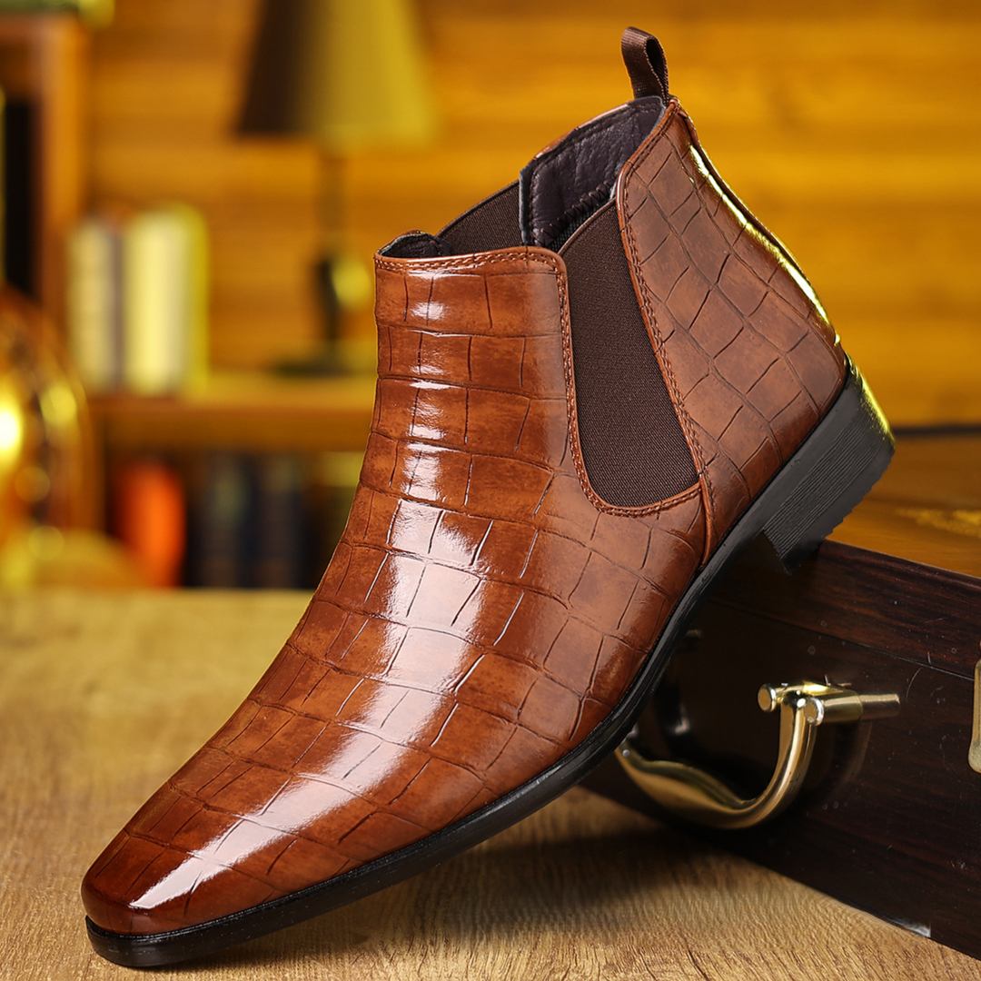 Close-up of men's elegant croc-embossed Chelsea boots, showcasing luxury texture & slip-resistant design for fashion.
