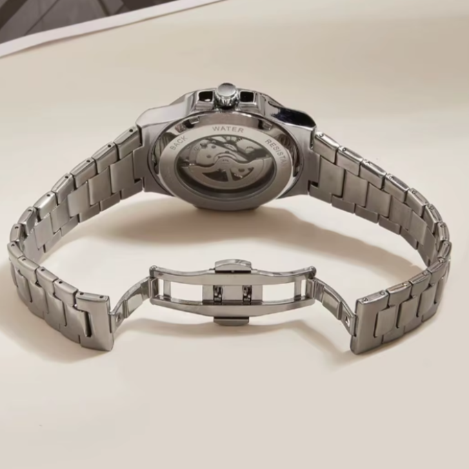 Men's stainless steel automatic skeleton watch on a wrist, demonstrating its fashion appeal
