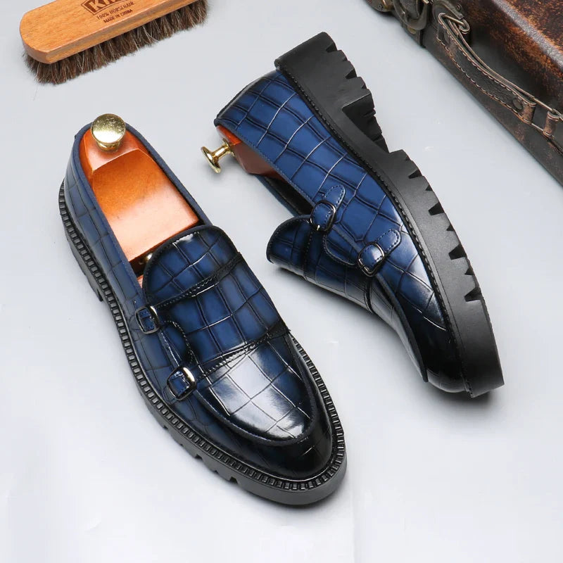 Close-up of a men's luxury loafer, showcasing detailed crocodile embossed leather texture and fine stitching.