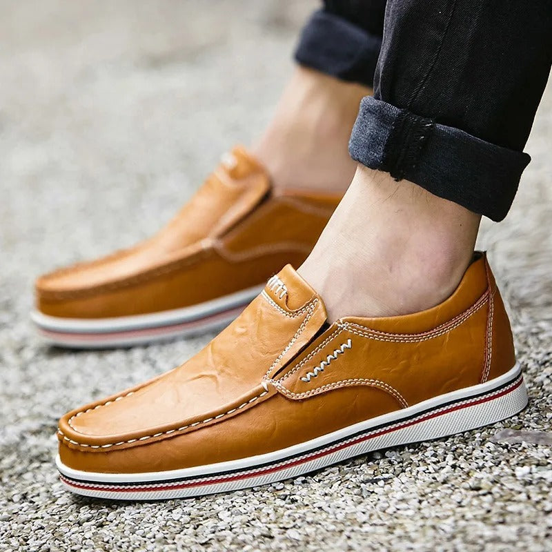 Casual yet sophisticated men's leather loafers in a rich tan, essential for modern wardrobes.