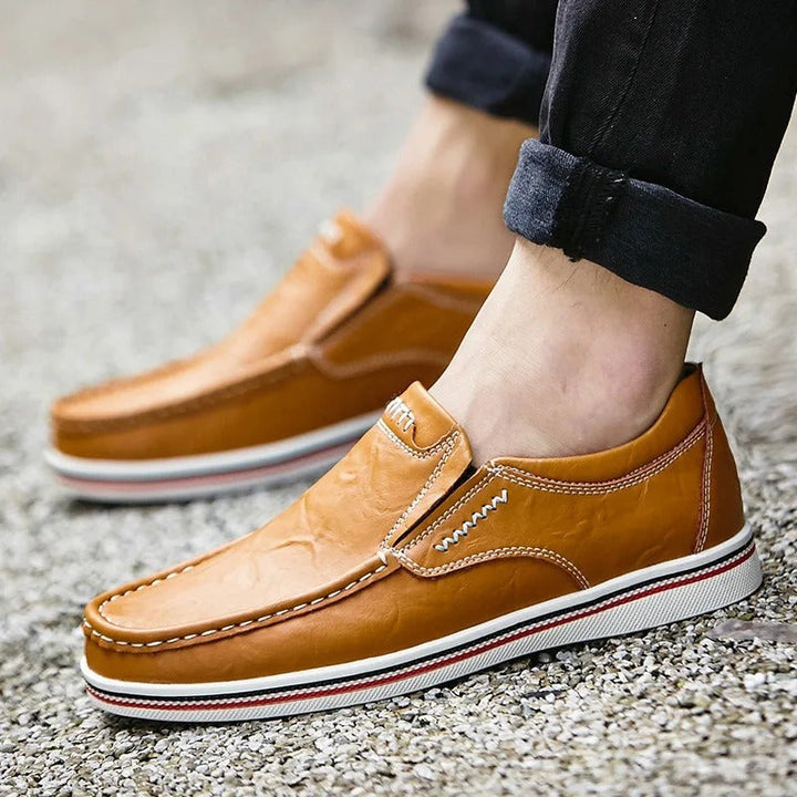 Casual yet sophisticated men's leather loafers in a rich tan, essential for modern wardrobes.