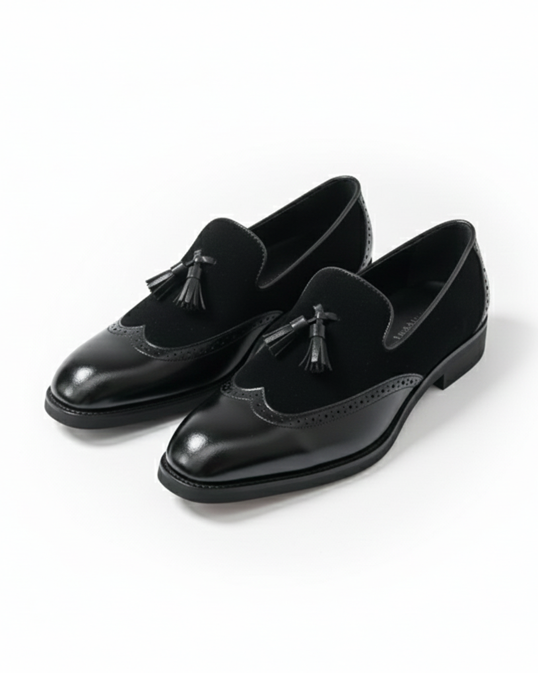 Men's luxury black leather loafers with tassel detail, front view, perfect for formal wear.