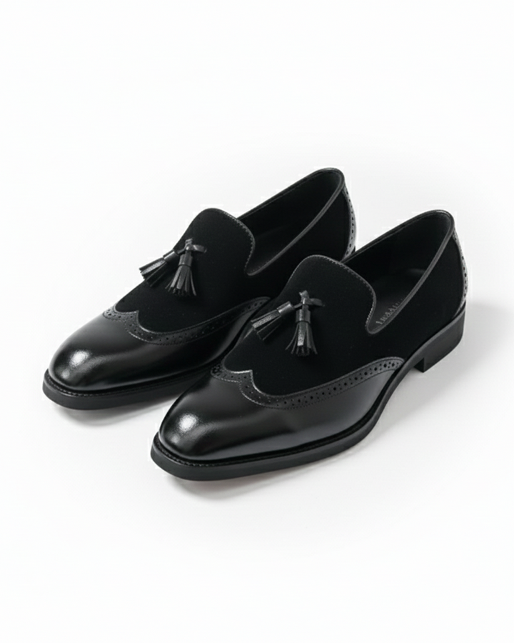 Men's luxury black leather loafers with tassel detail, front view, perfect for formal wear.