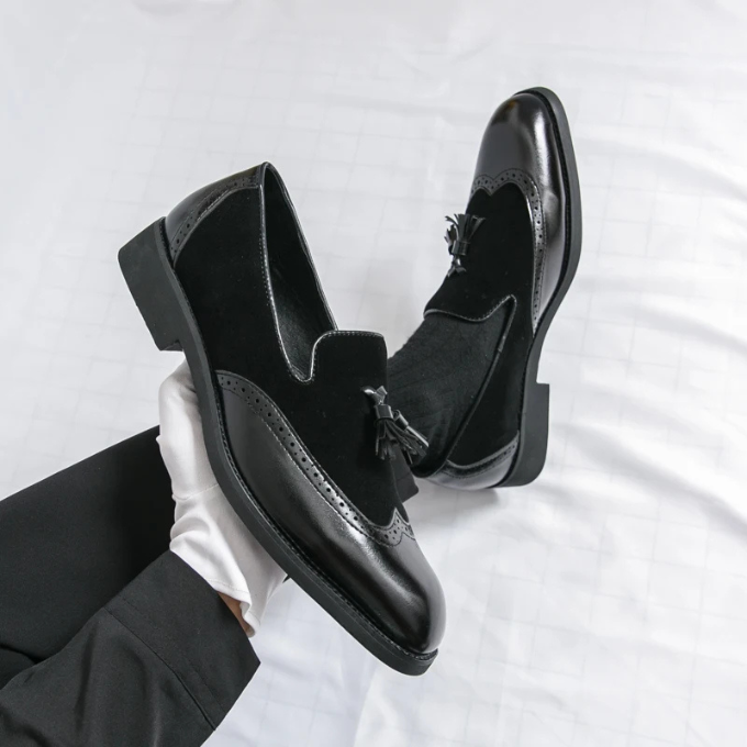 Close-up of the elegant tassel detail on men's black leather dress shoes, showcasing craftsmanship.