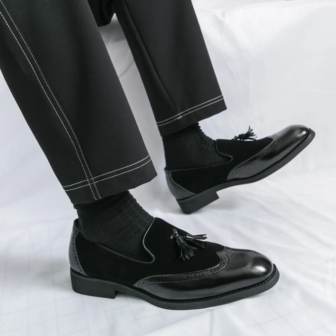 Side view of dapper men's loafers made from premium black leather, ideal for a gentleman's footwear.