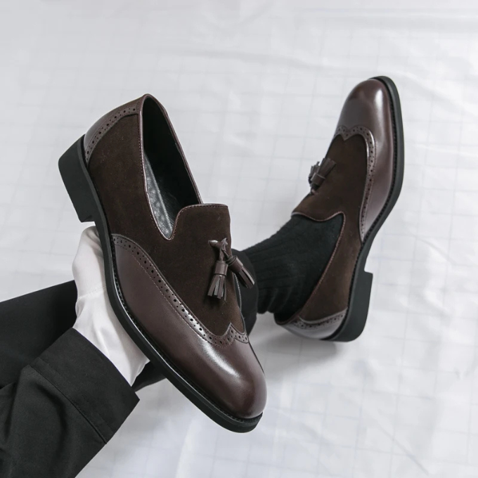 Pair of classic black leather loafers for men, designed with decorative tassels and comfort.