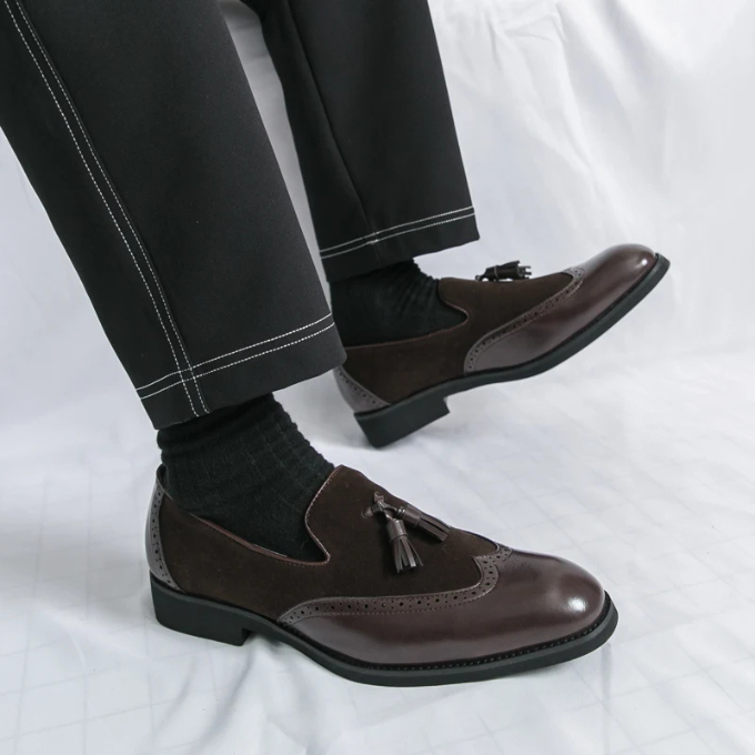 Detail of the fine leather texture on men's black dress loafers, emphasizing quality.