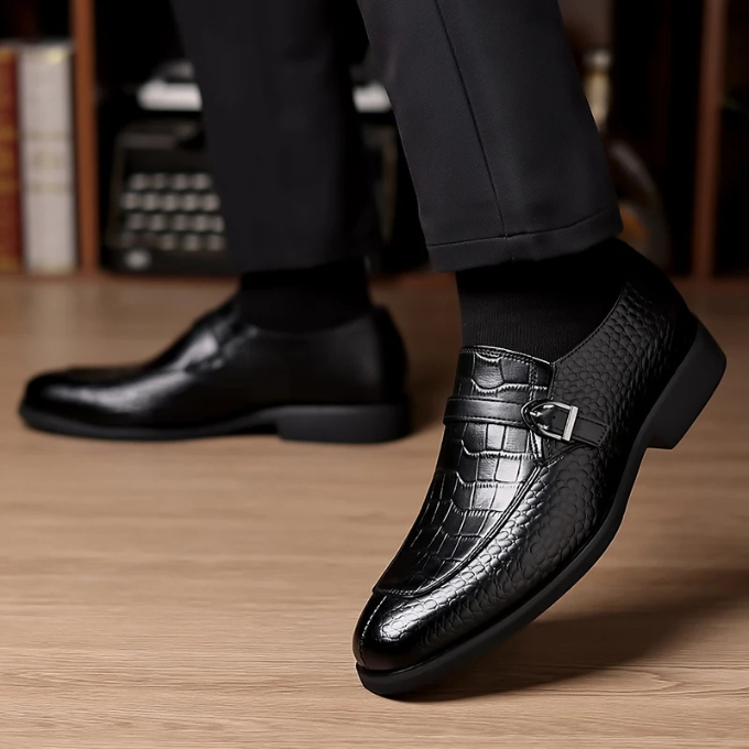 Top-down shot of men's sophisticated monk strap leather loafers, highlighting the two-buckle design and texture.