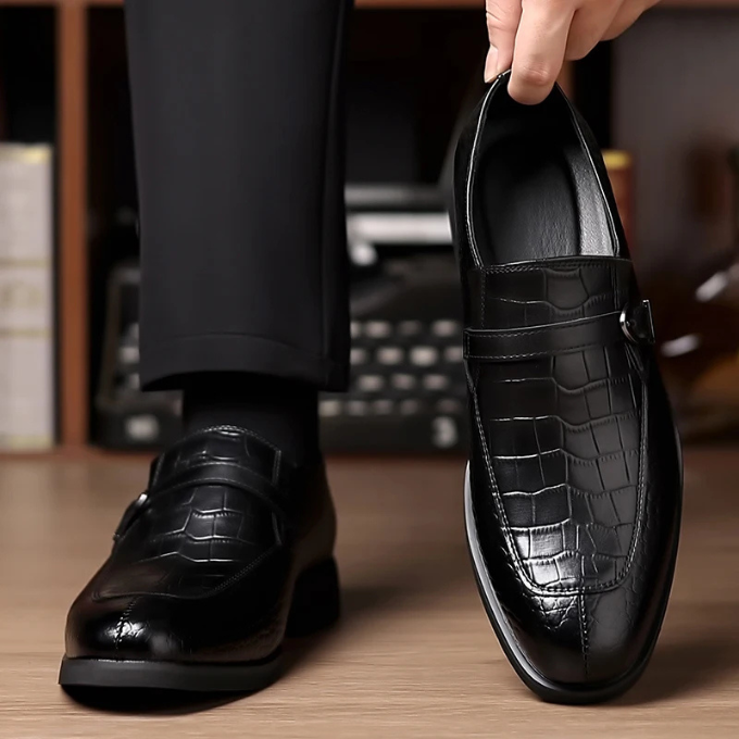 Men's fashion: monk strap leather loafers with a distinctive crocodile pattern, epitomizing executive style.