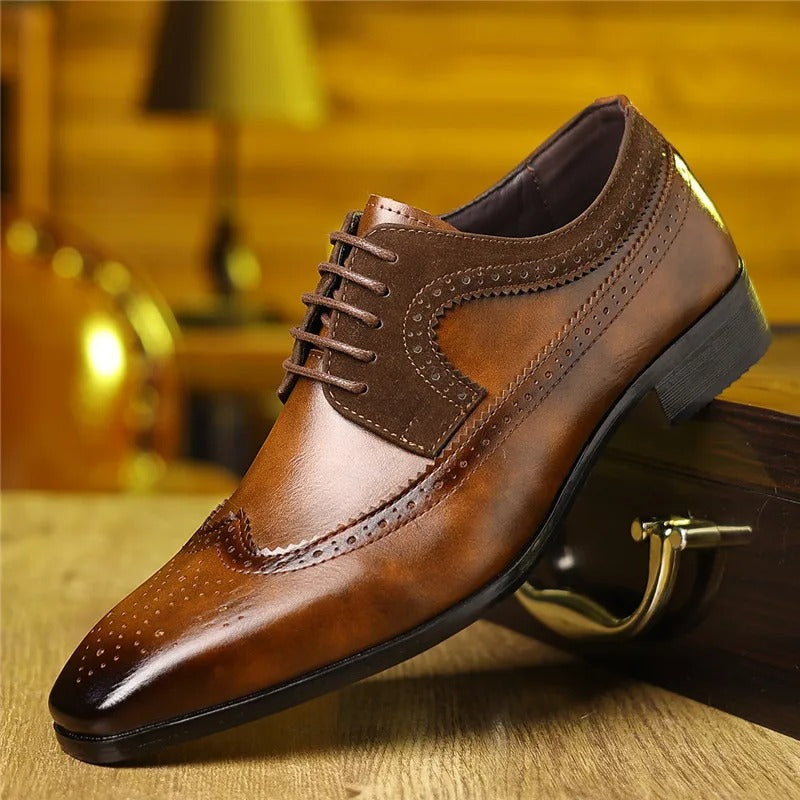 Close-up of elegant men's leather Oxford shoes featuring intricate brogue detailing for weddings.