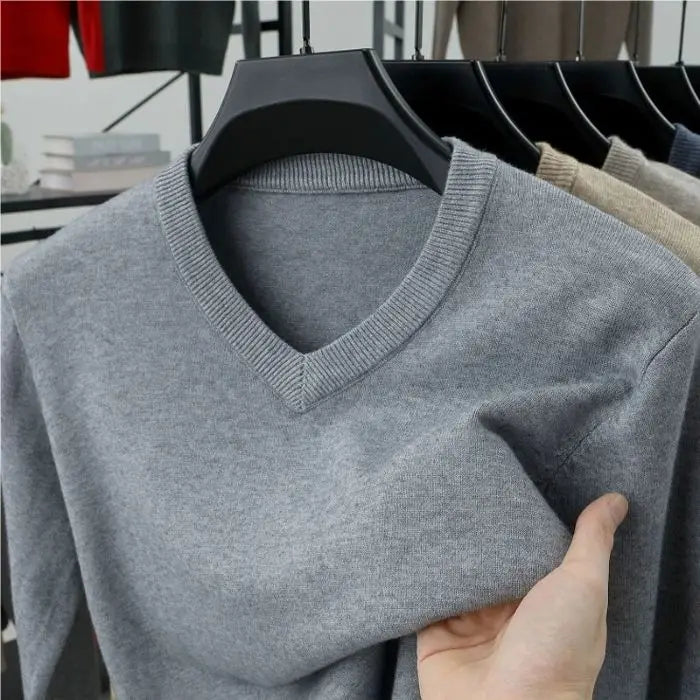 Close-up of a men's cashmere blend V-neck sweater showing the soft knit texture and luxurious feel.