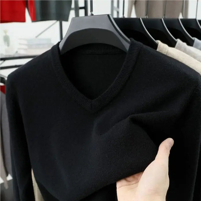 Stylish man wearing a charcoal cashmere-blend V-neck sweater, showcasing its elegant fit and winter appeal.