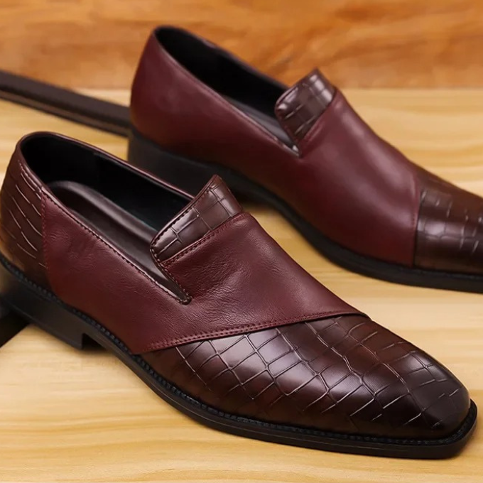 High-angle shot of men's black croc-textured loafers, emphasizing their refined appeal