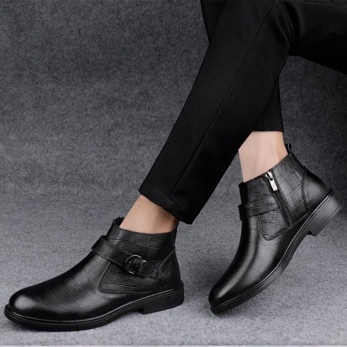 Bottom sole detail of men's durable full-grain leather ankle boots, built for long-lasting wear.