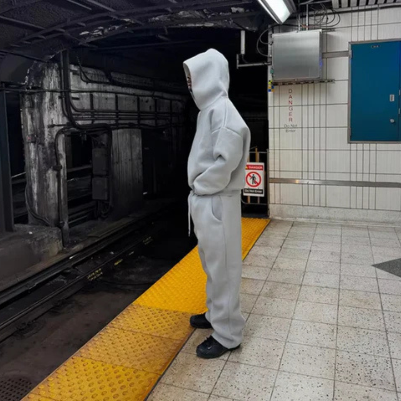 Matching men's sweatshirt and joggers set with hood in a clean, minimalist design for everyday wear