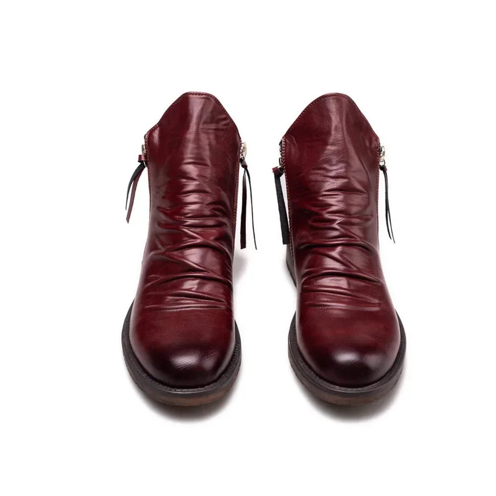 Close-up of a men's modern Chelsea boot, showcasing the smooth leather texture and ankle height.