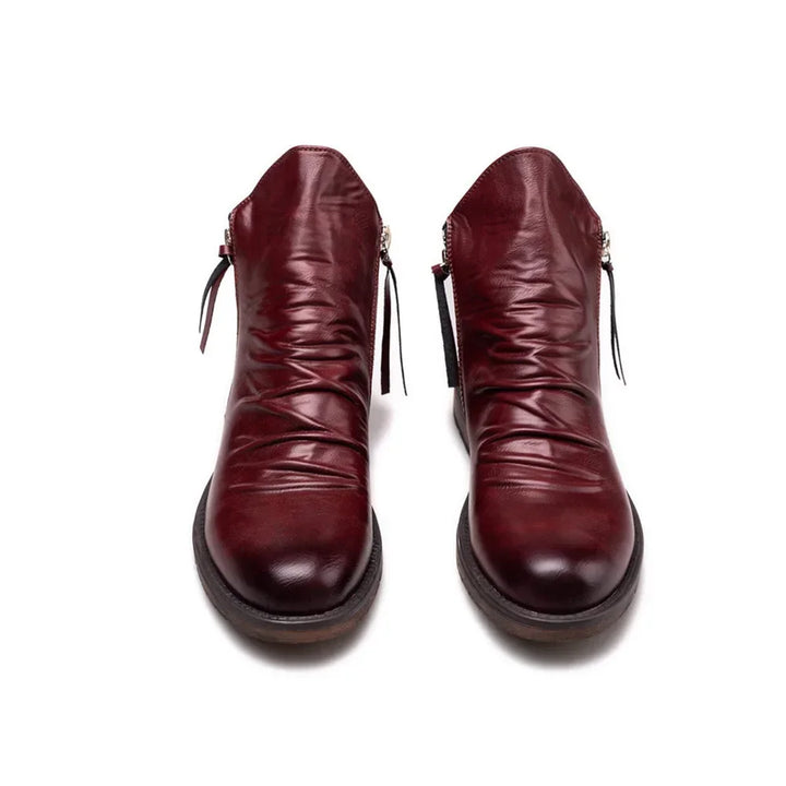 Close-up of a men's modern Chelsea boot, showcasing the smooth leather texture and ankle height.