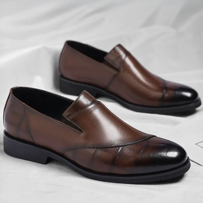 Front view of men's sleek black leather slip-on loafers, showcasing European style and comfortable fit
