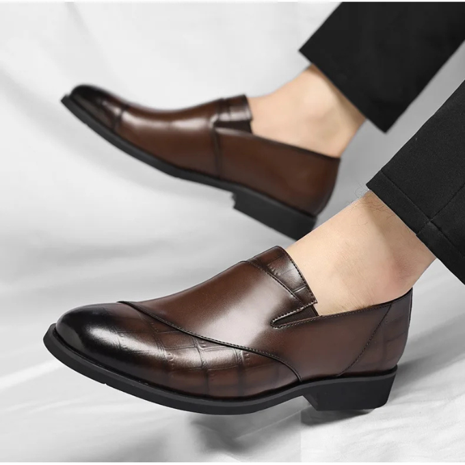Side profile of a classic men's polished leather slip-on loafer, ideal formal footwear option