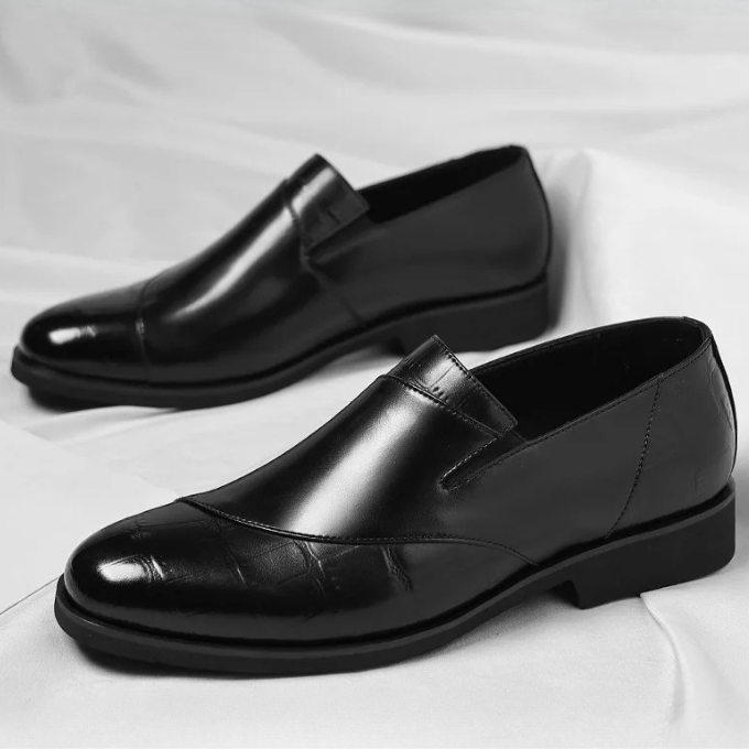 Man wearing sophisticated men's black leather slip-on loafers with a formal suit, fashion showcase