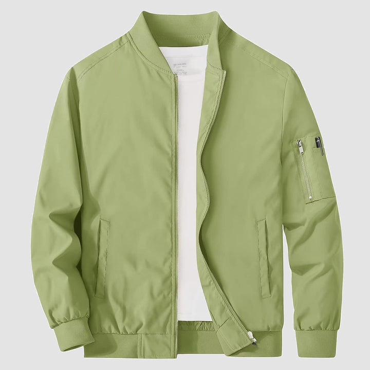 Full-length shot of men's bomber jacket, paired with jeans, showcasing casual versatility
