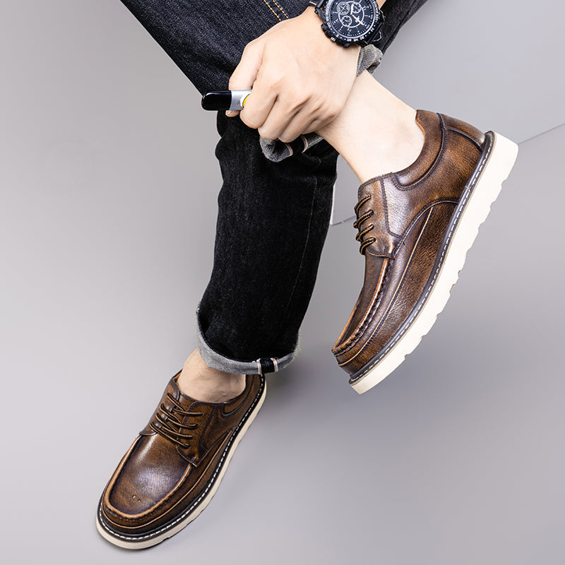 Grey modern casual men's boots styled with cuffed jeans, showcasing everyday fashion