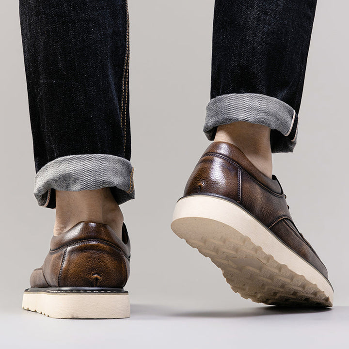 Back view of men's brown casual boots, emphasizing their sturdy and durable construction
