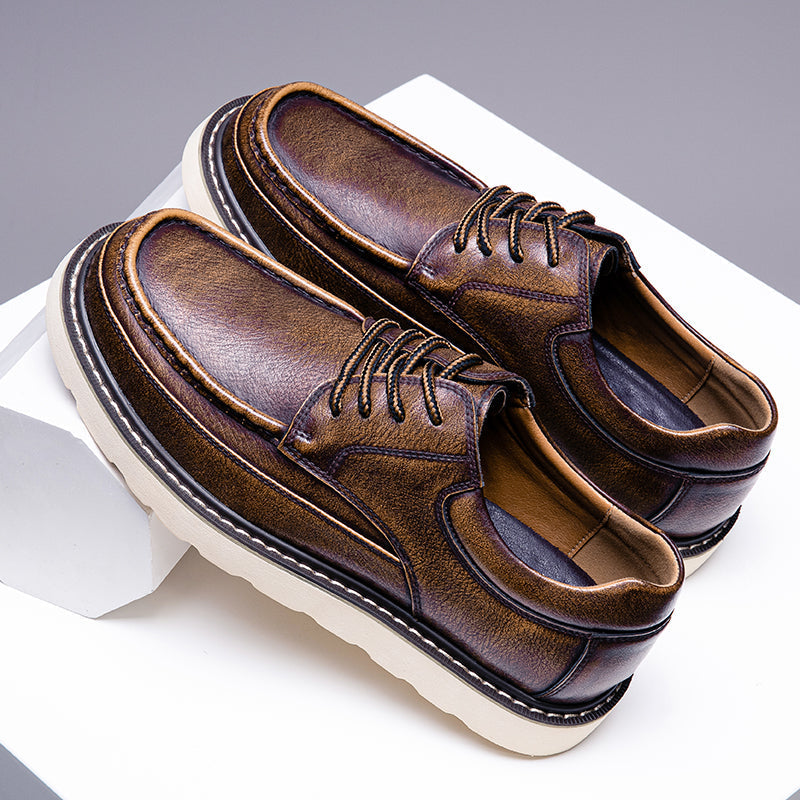 Close-up of brown leather men's modern casual boots, showing detailed stitching and texture