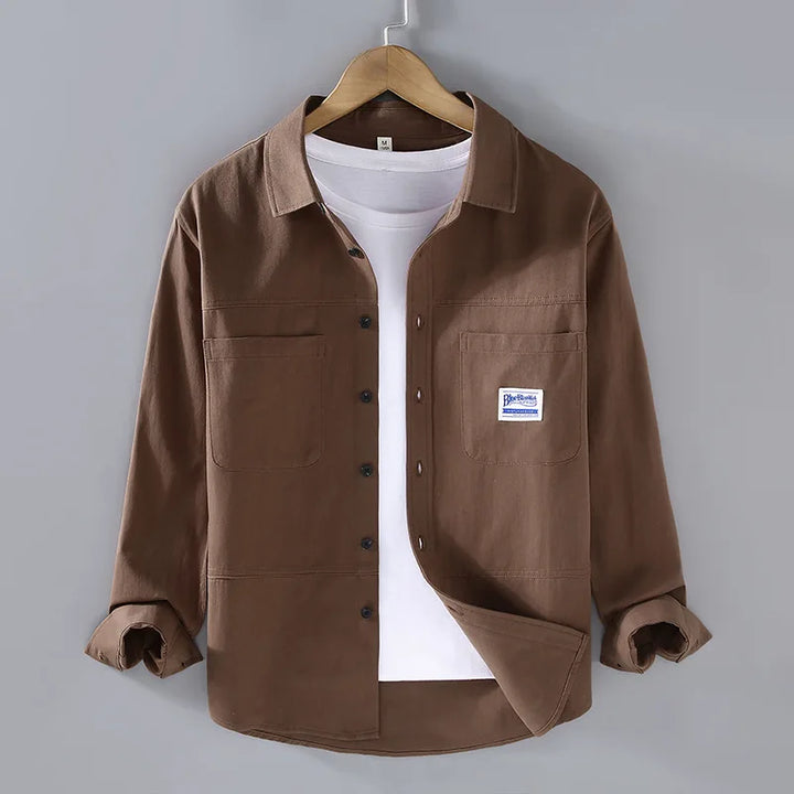 Close-up of a long sleeve men's button-down shirt in white, showing collar detail