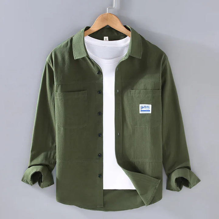 Stylish man wearing a modern fit casual button-down shirt with rolled sleeves