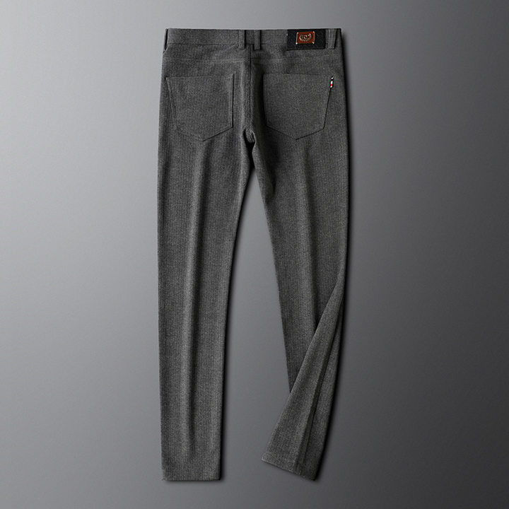 Man wearing smart casual khaki tailored trousers, paired with a white shirt, ideal for a contemporary look.