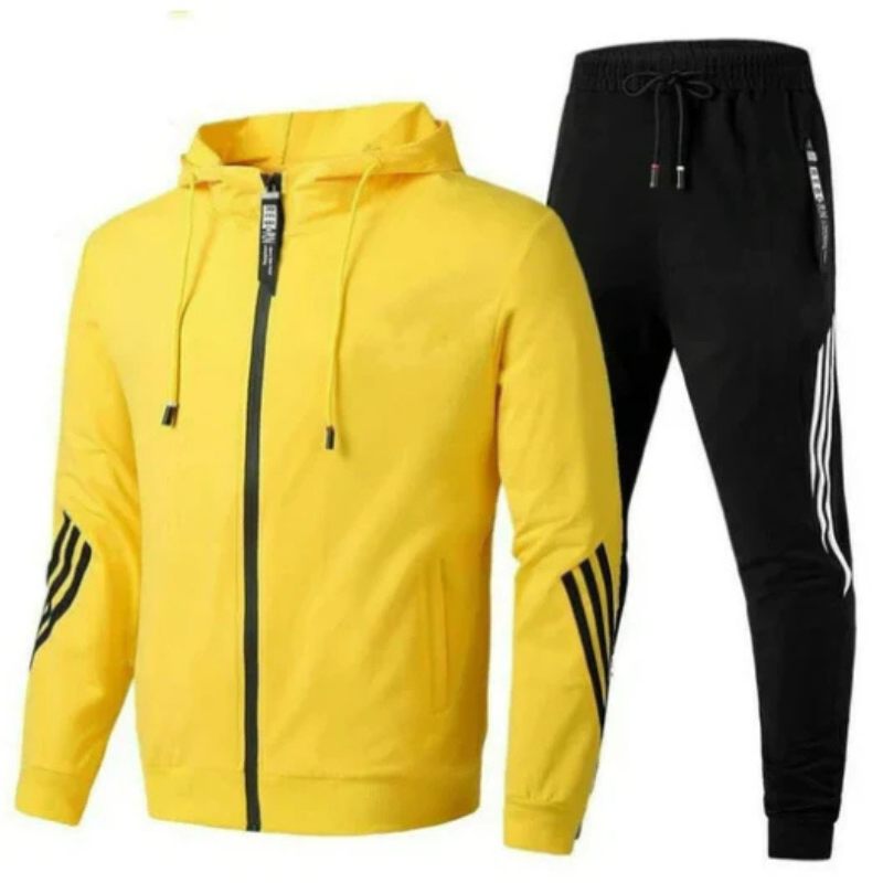 Man wearing a men's streetwear hoodie and jogger set outdoors, showcasing the modern style and fit.